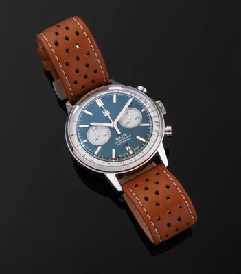 a close up of a watch on a black surface