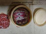 a wax seal on a piece of paper next to a wax seal