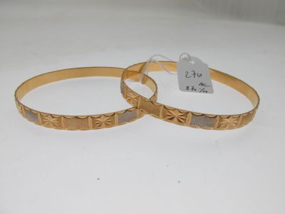paire de bracelets couleur or, avec un motif gravé de chaque côté
