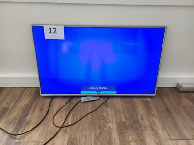 an image of a flat screen tv sitting on top of a wooden floor