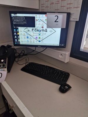 a desk with a keyboard and a monitor on it