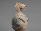 an image of a vase with a bird on top of it