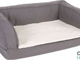 the dog bed is made of a soft fabric and has a white flee