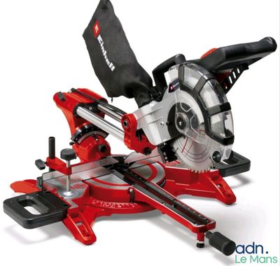 a close up of a red and black circular saw on a white background