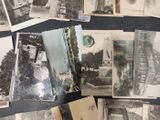 many old photographs of people and buildings on the table
