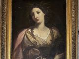 painting of a woman in a gold dress with a pink shawl on her head