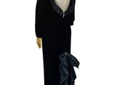 a mannequin wearing a black dress with a bow on it