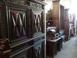 a room filled with lots of antique furniture in it
