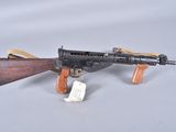 an old toy gun with a wooden handle and a tag on it