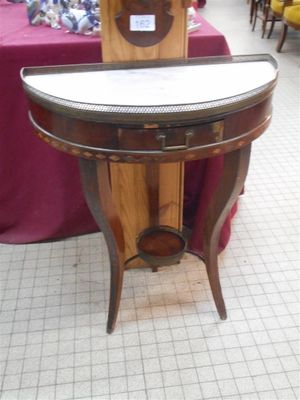 a small table with a clock on it in a store