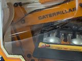 a box with a toy construction vehicle inside of it