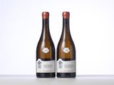 two bottles of wine sitting on top of a table