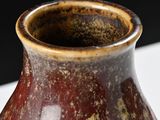 a close up of a vase on a table