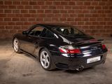 a picture of a black sports car parked in a garage