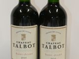 two bottles of red wine sitting next to each other on a table