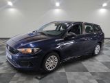 une voiture bleue est garée sur le sol à carreaux d'un garage