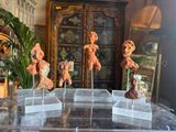 five teddy bears on display on clear acrylic stands
