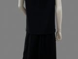 an image of a mannequin wearing a black dress and white shoes
