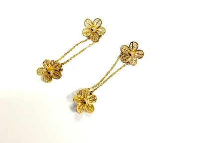 two pairs of gold earrings with flowers on them