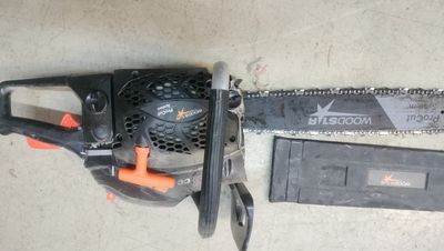 a chainsaw and a tool that is laying on the ground