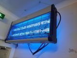 a blue light that is on the wall above a heater