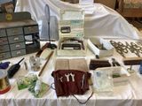 a table with a typewriter and many other items on it