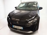 une voiture noire garée dans une pièce blanche