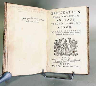 an open book with a pen on it sitting on a table