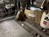 a forklift in a garage with a lot of tools