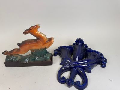 two figurines of a deer and a dog on a table