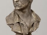 an image of a bust of a man on a wooden table
