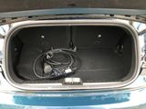 the trunk of a car with a car charger and cables in it