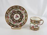 a close up of a cup and saucer on a table