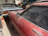 many old cars parked in a garage together