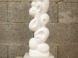 a white sculpture sitting on top of a wooden table