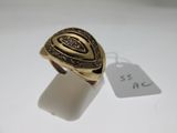 a close up of a gold ring with a tag on it