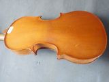 an old violin sitting on top of a gray surface