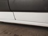a white car with a black stripe parked in a parking lot