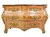 a wooden chest of drawers with gold decorations on it