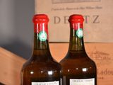 two bottles of wine sitting on a table next to a box