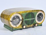 a green and gold radio sitting on a white surface