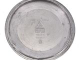 a close up of a silver plate on a white surface