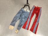 pair of red and blue pants on a hanger next to a pair of blue and red pants