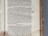 an open book with a torn page on top of it