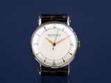 a watch that is sitting on a blue surface
