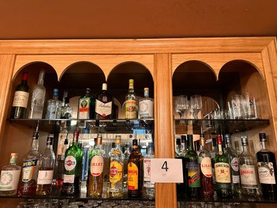 many bottles of alcohol on the shelves in the bar