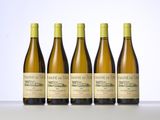 four bottles of wine are lined up on a table