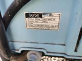 a close up of a blue machine with a label on it