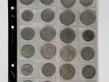 a lot of coins in a plastic case on a table