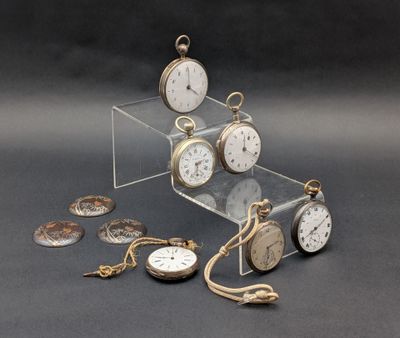 many different types of pocket watches displayed on the table